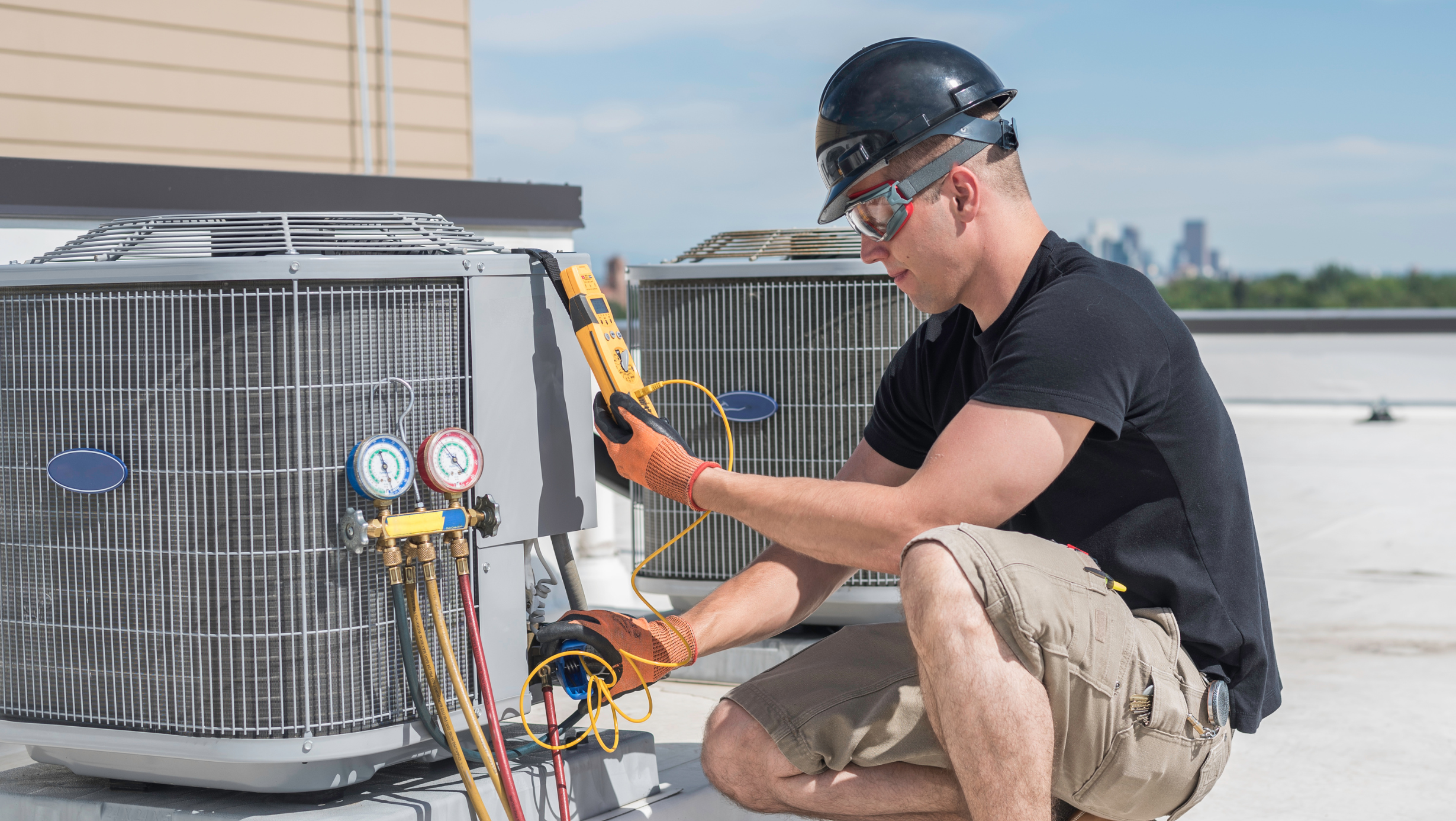 HVAC technician working on AC unit